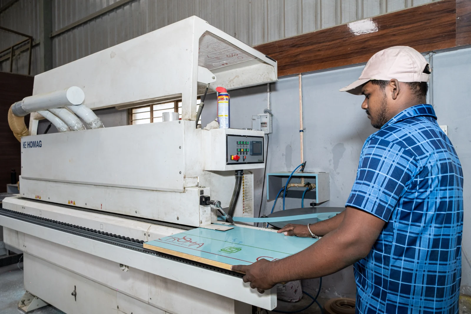 Grihala team member operating the edgebanding machine
